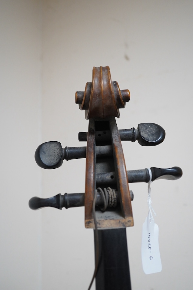 A late 19th century small cello, unsigned and without label inside body, stamped inventory number 769, length of back 62cm. Condition - poor to fair